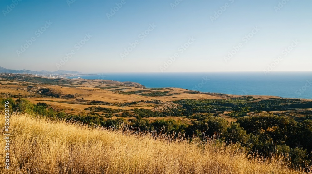 The view from Filerimos Hill, capturing the sweeping landscapes and sea in the southwest direction under a clear sky.
