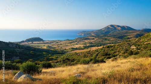 The view from Filerimos Hill, capturing the sweeping landscapes and sea in the southwest direction under a clear sky. photo