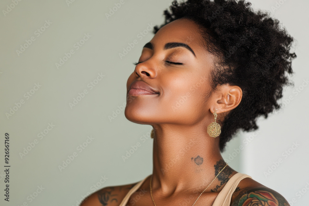 A close up of a tattooed black woman's face with her eyes closed A close up of a tattooed black woman's face with her eyes closed