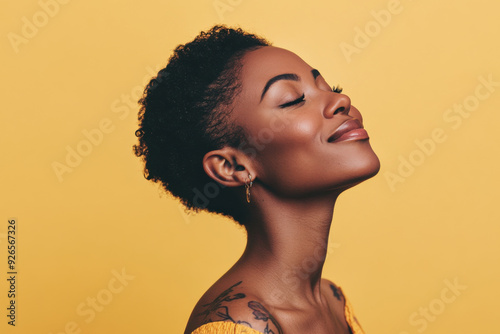 A close up of a tattooed black woman's face with her eyes closed