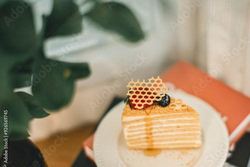 Artisanal Honey Layer Cake: Golden Honeycomb and Berry Garnish on Rustic White Plate. Perfect for Dessert and Pastry Lovers