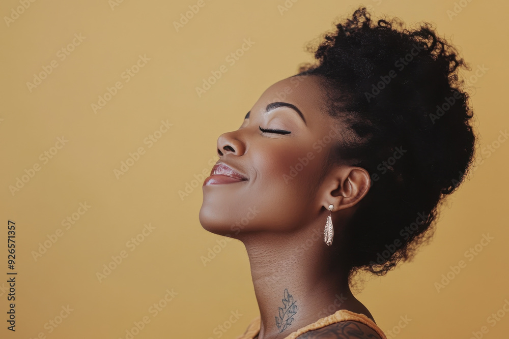 A close up of a tattooed black woman's face with her eyes closed A close up of a tattooed black woman's face with her eyes closed