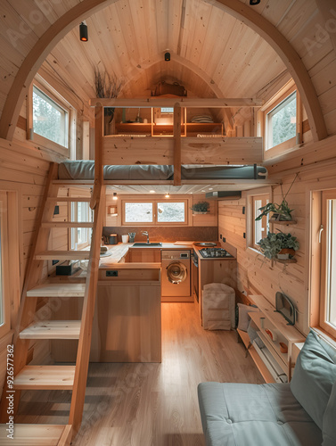 extreme wide shot in a tiny house interior with gorgeous architecture design style with kitchen, a loft with stairs, railings and a bed, real photo