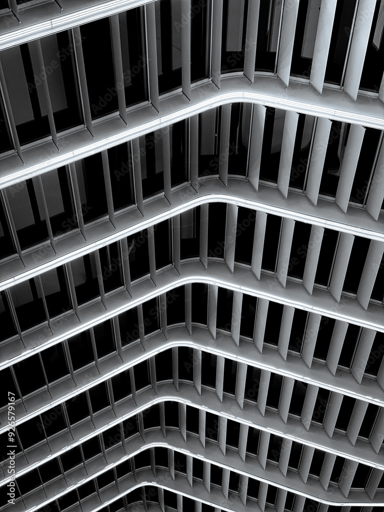 Modern architectural detail with curved, parallel white structures and integrated LED lighting. Striking contrast creates a futuristic, abstract ambiance. Modern architectural detail with curved, parallel white structures and integrated LED lighting. Striking contrast creates a futuristic, abstract ambiance.
