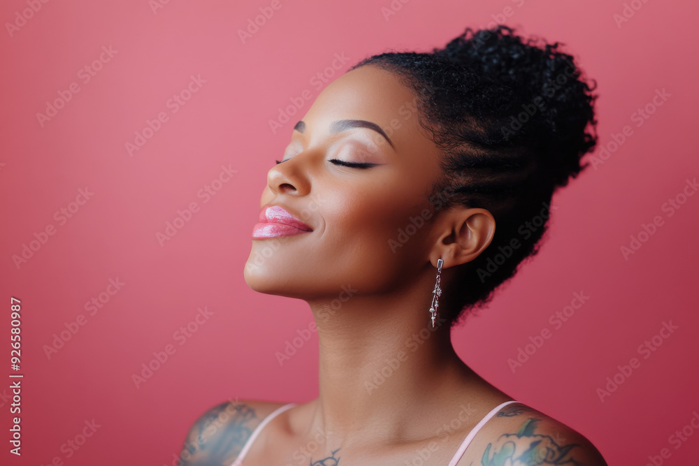A close up of a tattooed black woman's face with her eyes closed A close up of a tattooed black woman's face with her eyes closed