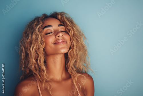 A close up of a black woman's face with her eyes closed and long blond hair