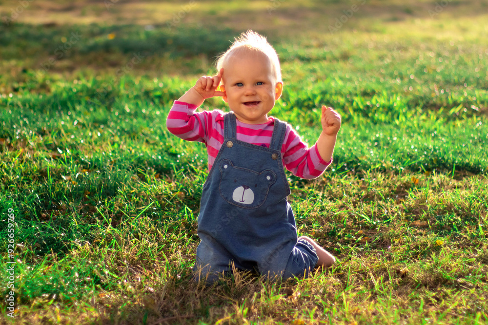 A Cute Baby Delightfully Having Fun While Enjoying Nature and Playing in the Warm Sunshine