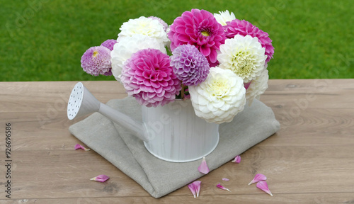 Flower arrangement with dahlia flowers on a table in the garden. photo