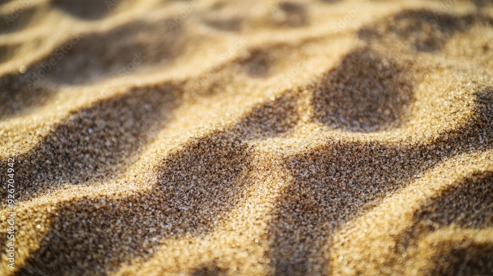 Close-up of sunlit sandy waves on the beach, showcasing textures and natural patterns created by wind and water erosion. Calm summer setting. Close-up of sunlit sandy waves on the beach, showcasing textures and natural patterns created by wind and water erosion. Calm summer setting.