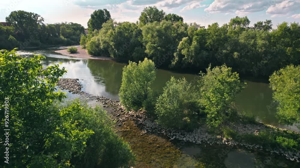 Aerial view of a river with lush green trees on the riverbed and flying birds landing on the water. Beautiful landscape on a sunny day
Aerial view of a river with lush green trees on the riverbed and flying birds landing on the water. Beautiful landscape on a sunny day