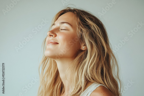 A close up of a black woman's face with her eyes closed and long blond hair