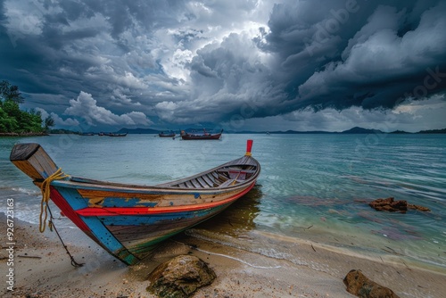 A Colorful Longtail Boat on a Sandy Beach in Thailand photo