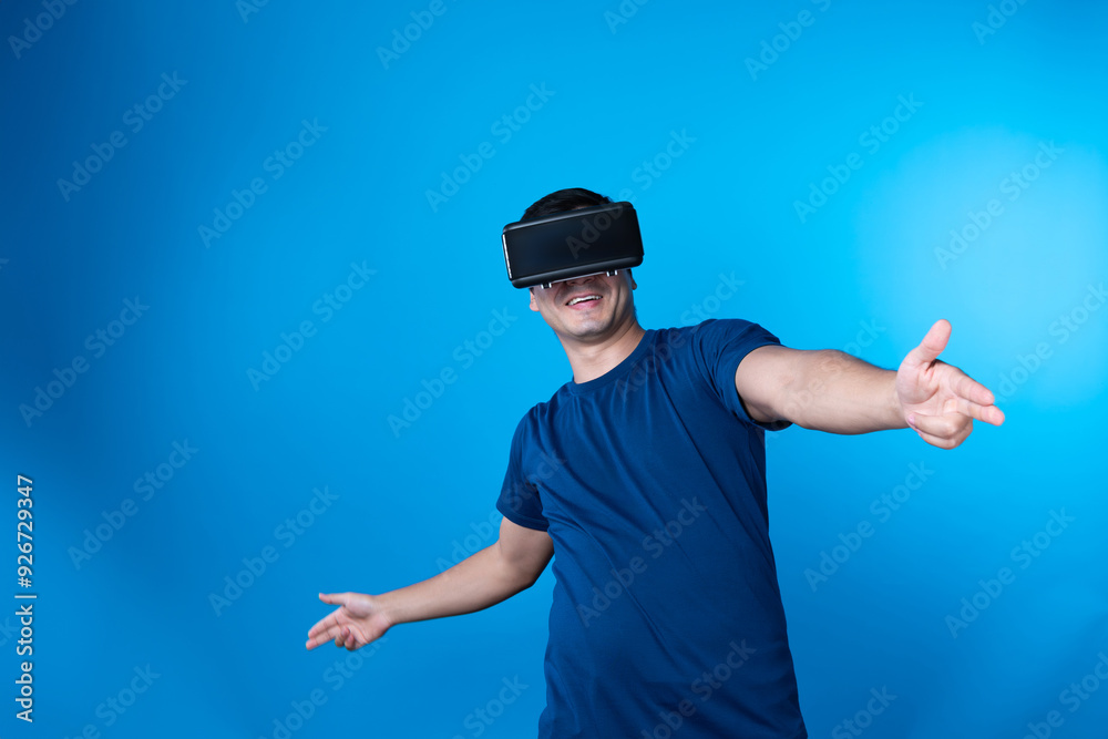 Naklejka premium Smart gamer wearing VR turning to metaverse world playing gun shooting hunter isolated blue background connecting to victory animal hunting futuristic technology hologram virtual reality. Contrivance.