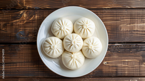 Delicious steamed buns on white plate, rustic table. Perfect for snack, lunch, dinner. Ideal for menus, food backgrounds photo