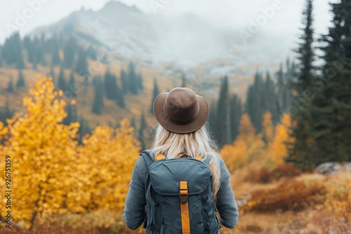 Hiker exploring autumn landscape in the mountains during overcast weather