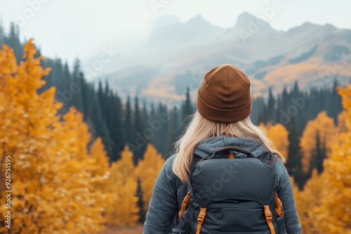 Hiker exploring autumn landscape in the mountains during overcast weather