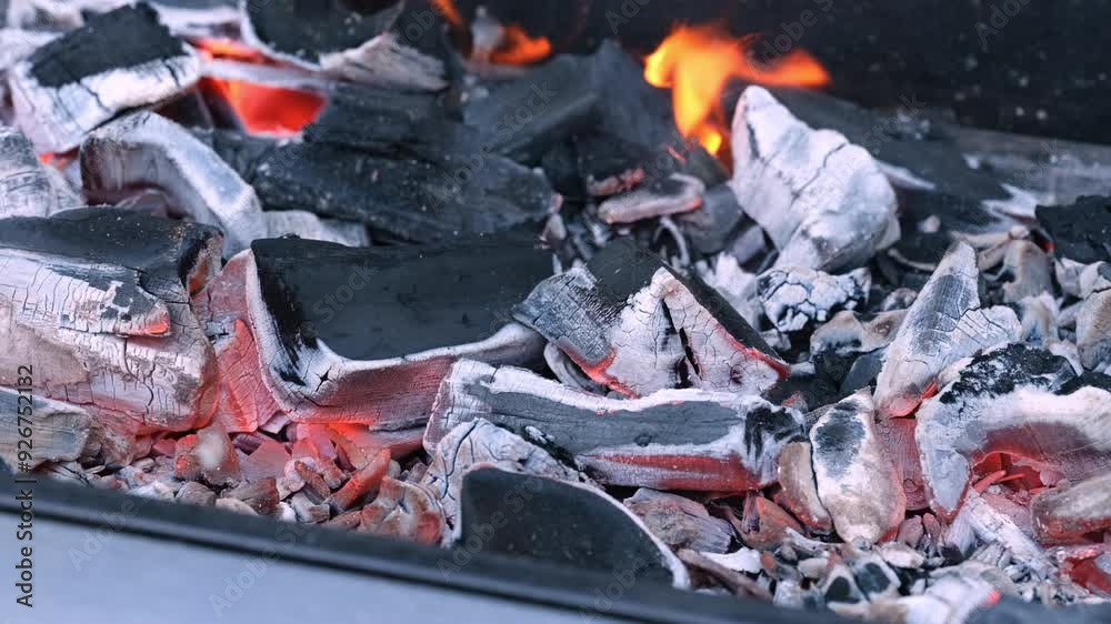 Charcoal burning in a grill. Close up. Charcoal burning in a grill. Close up.