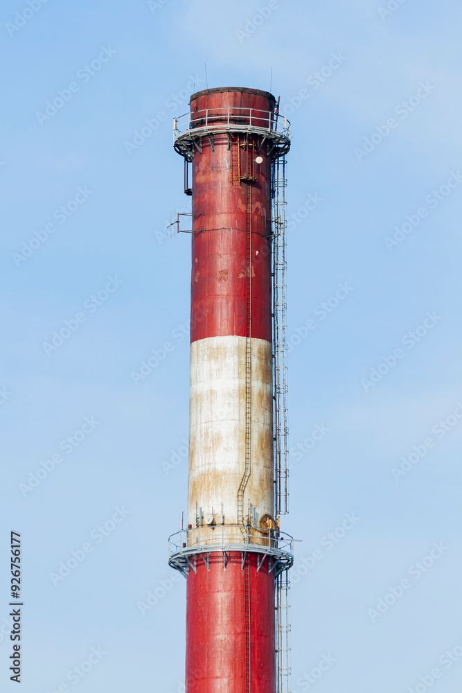 An industrial chimney against a clear sky, painted white and red | Komin przemysłowy na tle czystego nieba, pomalowany na biało-czerwono An industrial chimney against a clear sky, painted white and red | Komin przemysłowy na tle czystego nieba, pomalowany na biało-czerwono