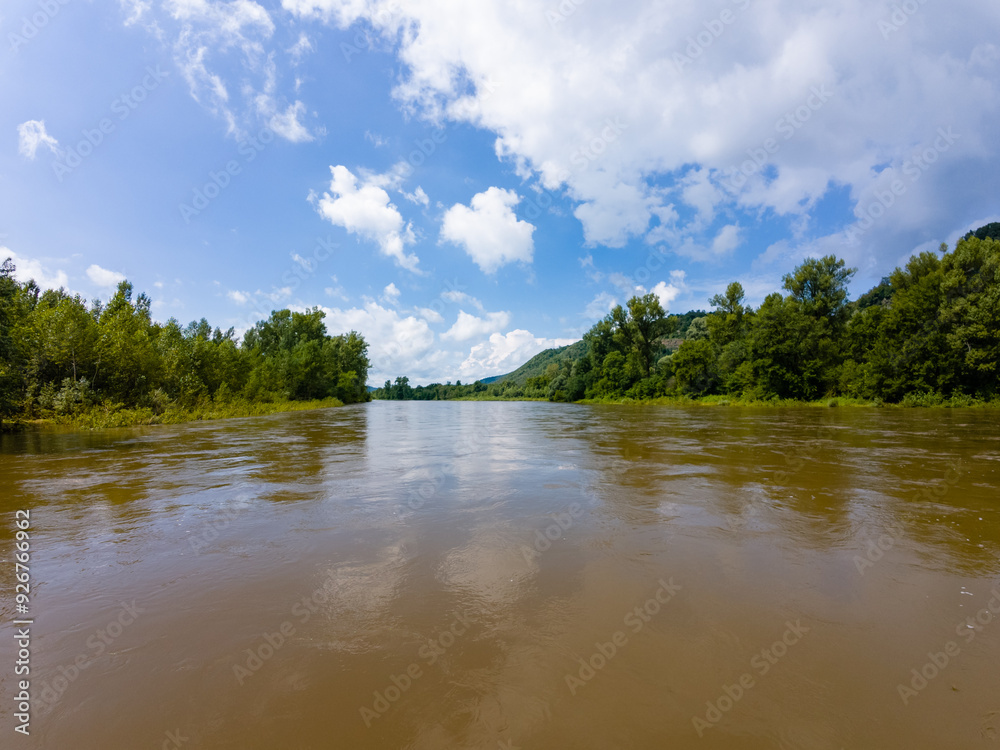 Imagine a vast expanse of water, surrounded by lush green trees, basking in the warm sunlight of a beautiful day, creating a serene and picturesque natural landscape thats truly breathtaking Imagine a vast expanse of water, surrounded by lush green trees, basking in the warm sunlight of a beautiful day, creating a serene and picturesque natural landscape thats truly breathtaking