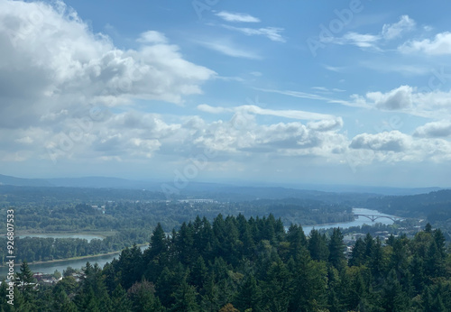 Scenic view of the Willamette Valley River running through Portland OR. Beautiful clear day with white puffy clouds overhead. 