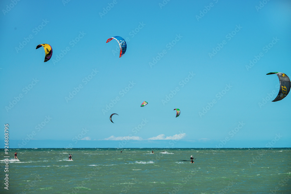 Practice of Kiteboarding or kitesurfing, a sport that involves using wind power with a large power kite to pull a rider across a water, land, snow, sand. Cumbuco Beach, Fortaleza, Ceara, Brazil. 2020 Practice of Kiteboarding or kitesurfing, a sport that involves using wind power with a large power kite to pull a rider across a water, land, snow, sand. Cumbuco Beach, Fortaleza, Ceara, Brazil. 2020