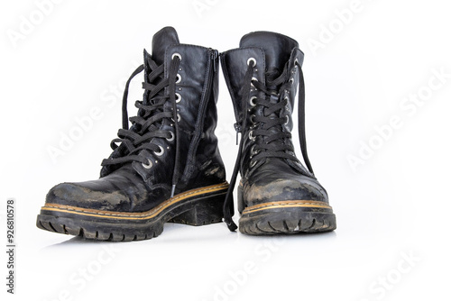 Pair of rugged worn black ankle leather combat boots with thick, sturdy soles and laces. Two vintage military style shoes. Studio light. Isolated on white background. Empty copy space. Clipping path