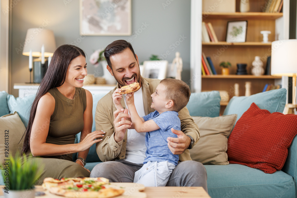 Mom, dad and son are eating together at home