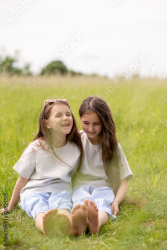 two sisters sitting on the grass