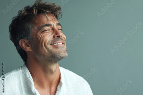 A close up of a man's face with her eyes closed