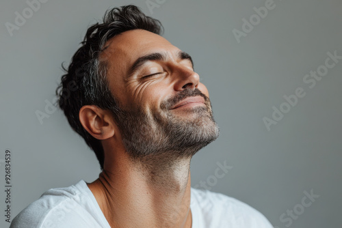 A close up of a man's face with her eyes closed