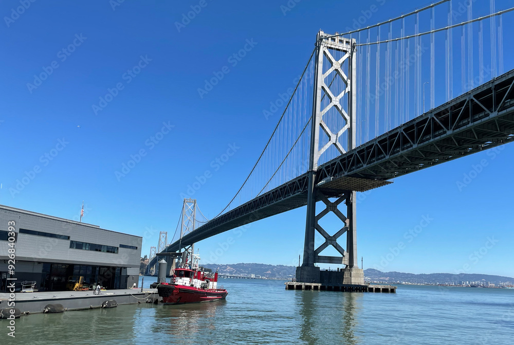 Fototapeta premium San Francisco Bay Bridge with fireboat