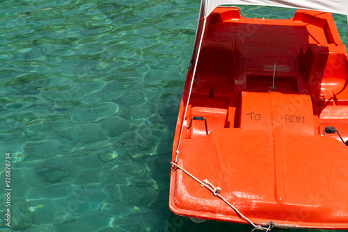 A red boat for rent to tourists.