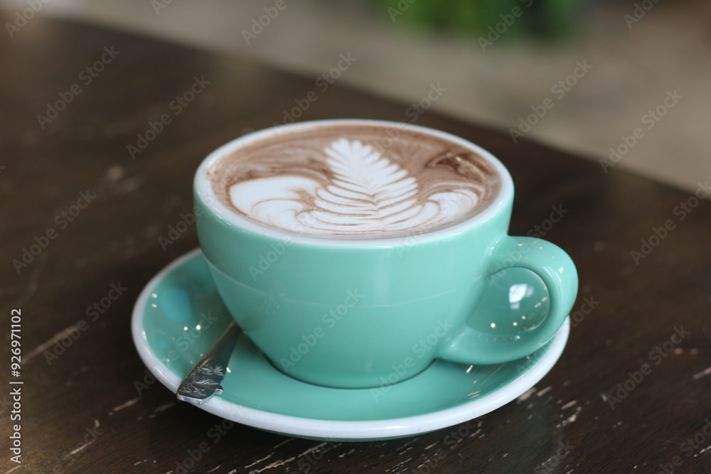 Fototapeta premium Hot chocolate on wooden table in cafe