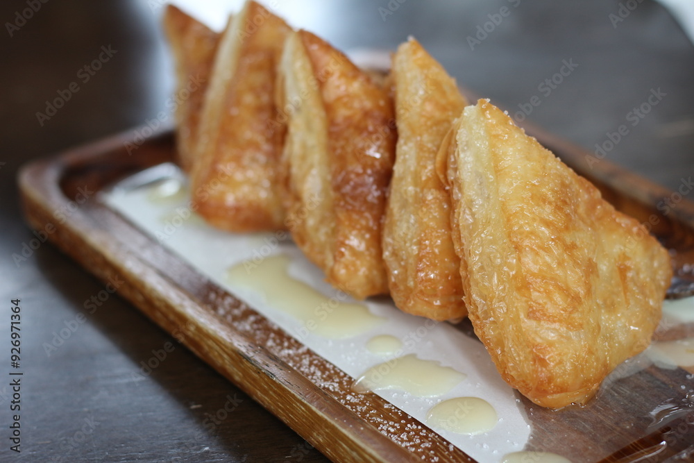 Crispy bread with sweetened condensed milk on table in coffee shop. Crispy bread with sweetened condensed milk on table in coffee shop.