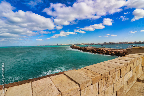 View of the azure blue and green shades of the Mediterranean sea and Alexandria city skyline from the Citadel of Qaitbay,built by the Mamluk Sultan Qaitbay in 1479 AD,Pharos Island,Alexandria,Egypt