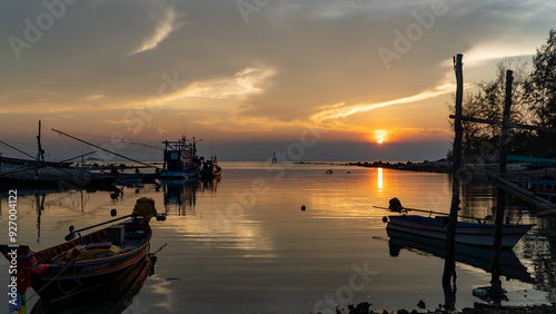 Stunning sunset painting the sky over boats on the water