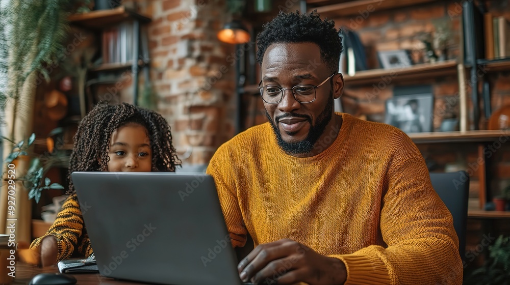 A man in a yellow sweater sits at a table with a laptop, while a little girl watches him with curiosity. The scene is cozy and warm, with a brick wall and shelves filled with books in the background. A man in a yellow sweater sits at a table with a laptop, while a little girl watches him with curiosity. The scene is cozy and warm, with a brick wall and shelves filled with books in the background.