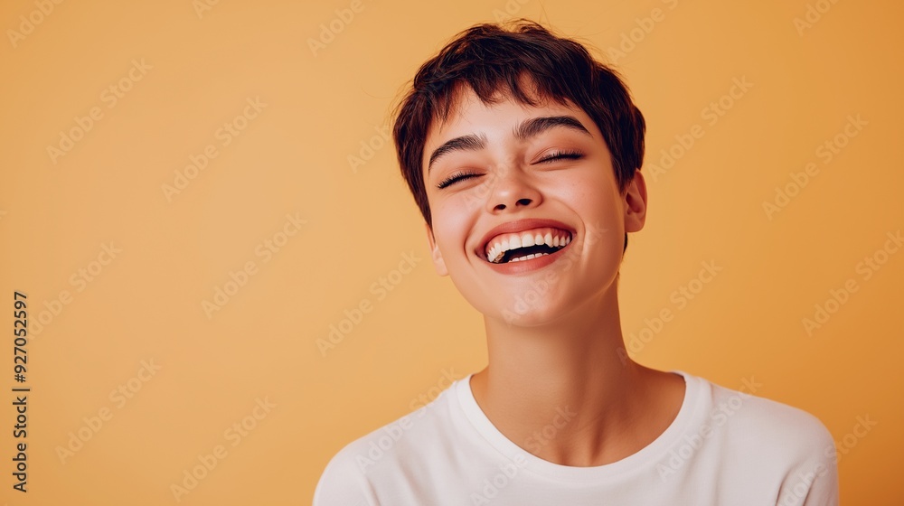 Fototapeta premium Laughing Woman in White Shirt on Orange Background