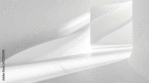 Sunlight streams through a window, casting long shadows and highlighting the curves of a white wall inside a modern building. The minimalist design creates a sense of calm and serenity, emphasizing th