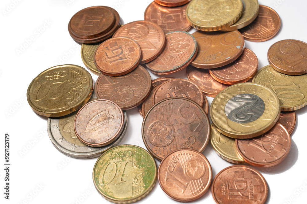 Different europian coins on white. Concept of saving, poverty, inflation, rising prices, cashback Different europian coins on white. Concept of saving, poverty, inflation, rising prices, cashback