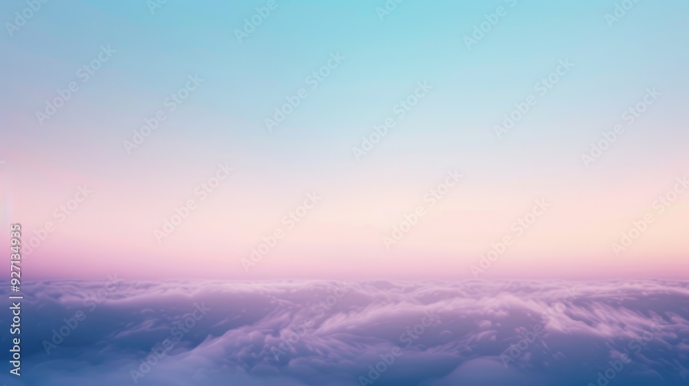 A view of a soft pastel pink and blue sky over a field of white clouds. The scene appears to be taken from above, possibly from an airplane. The light is soft and warm, casting a glow over the clouds. A view of a soft pastel pink and blue sky over a field of white clouds. The scene appears to be taken from above, possibly from an airplane. The light is soft and warm, casting a glow over the clouds.