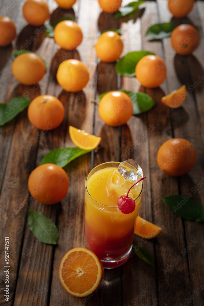 Tequila sunrise cocktail on an old wooden table. Tequila sunrise cocktail on an old wooden table.