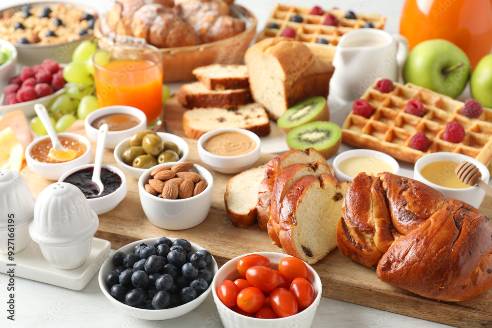 Different meals served for breakfast on white table Different meals served for breakfast on white table