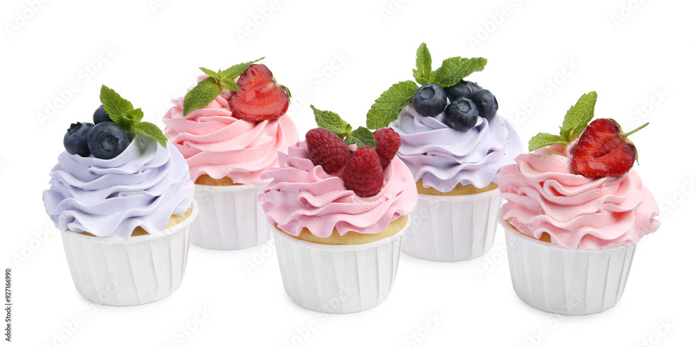 Tasty cupcakes with different berries isolated on white Tasty cupcakes with different berries isolated on white