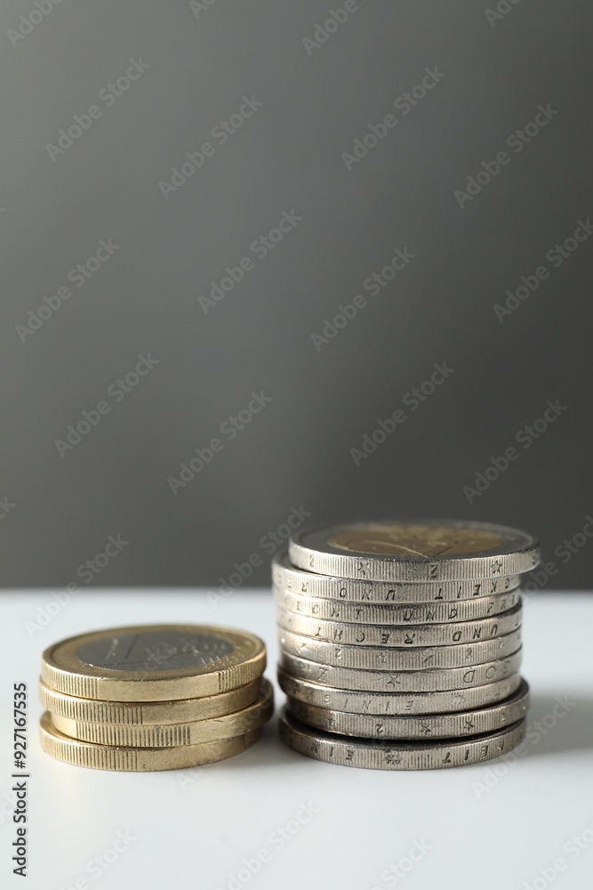 Stacked euro coins on white table, space for text Stacked euro coins on white table, space for text