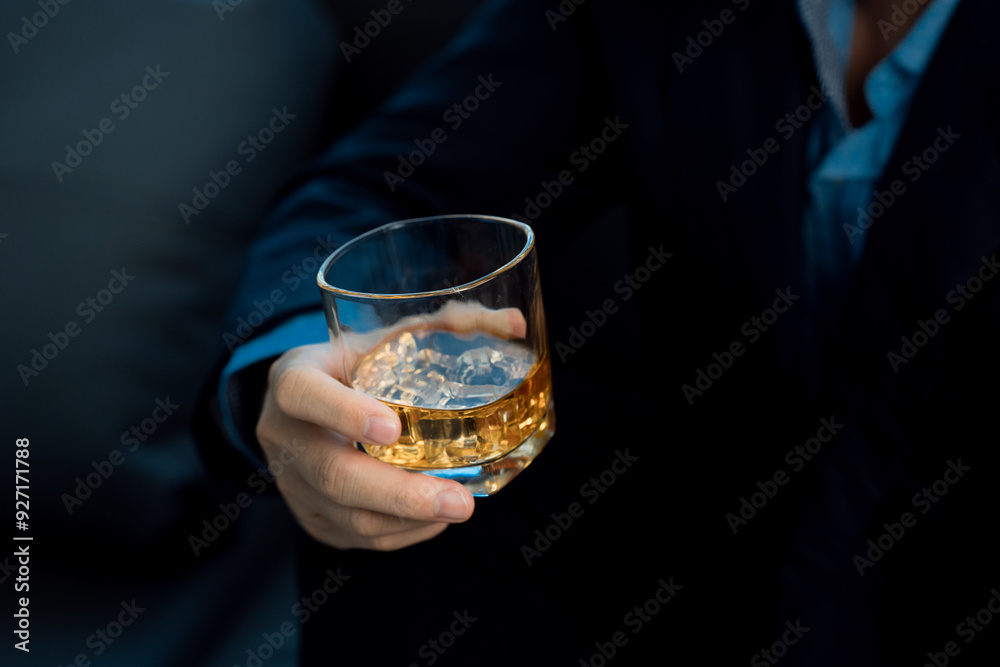 Businessmen discussing work and drinking Vikis in a dark room, close-up photo Businessmen discussing work and drinking Vikis in a dark room, close-up photo