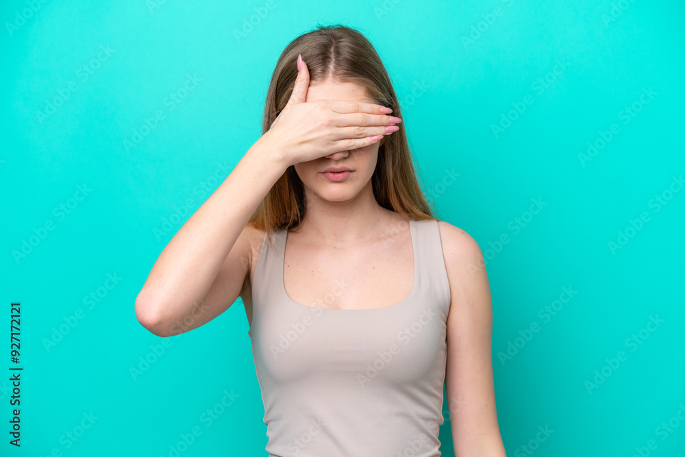 Teenager Russian girl isolated on blue background covering eyes by hands. Do not want to see something Teenager Russian girl isolated on blue background covering eyes by hands. Do not want to see something