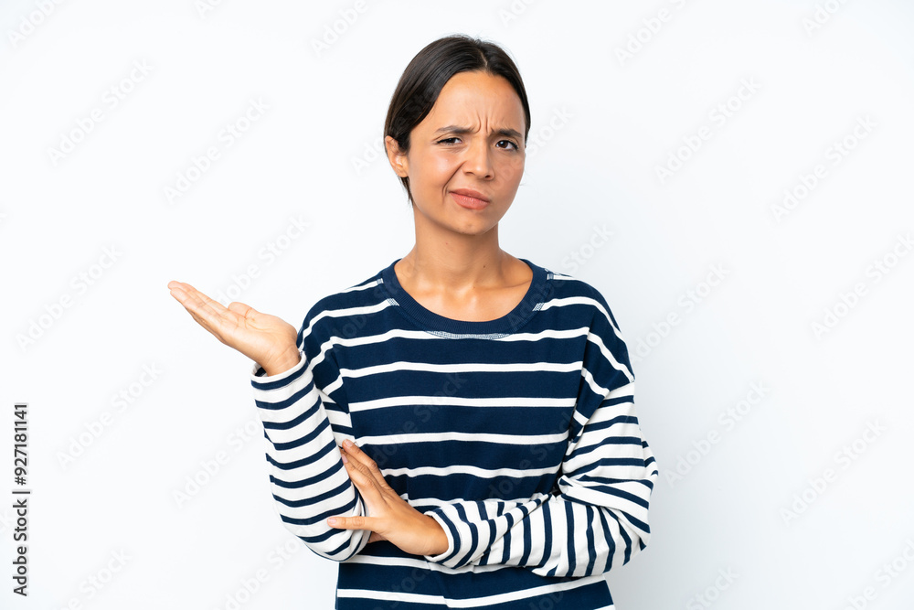 Young hispanic woman isolated on white background having doubts Young hispanic woman isolated on white background having doubts