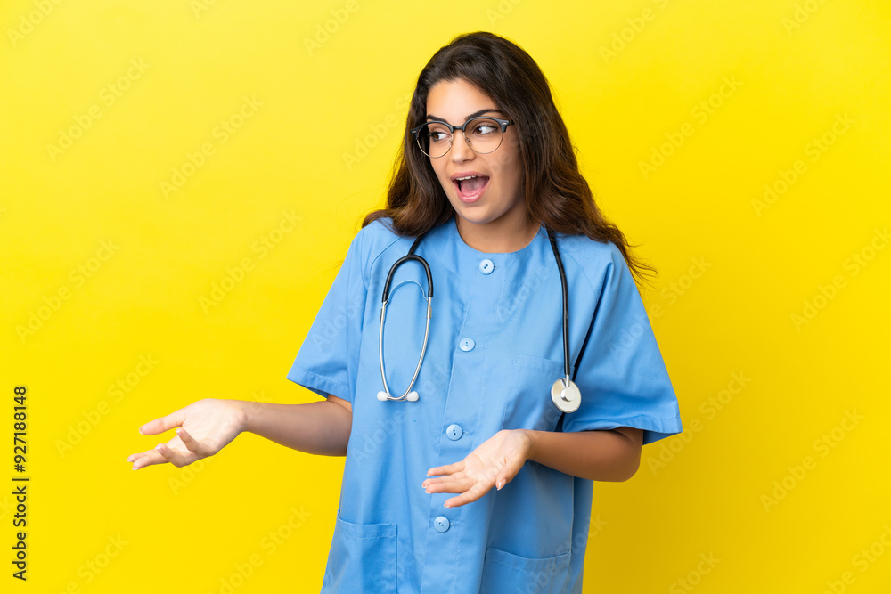 Young surgeon doctor woman isolated on yellow background with surprise facial expression Young surgeon doctor woman isolated on yellow background with surprise facial expression