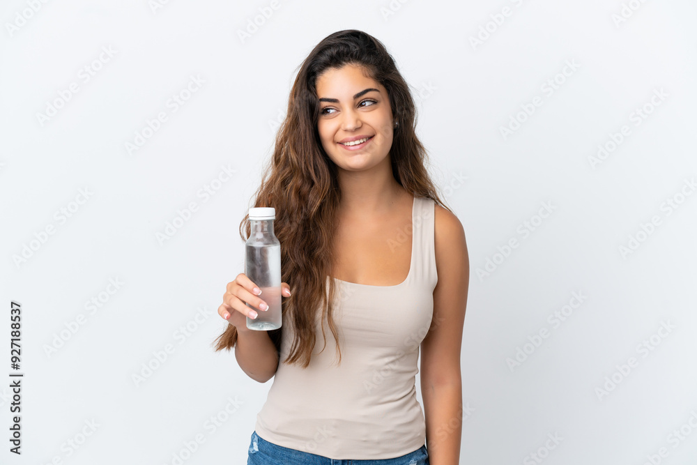 Young caucasian woman with a bottle of water isolated on white background thinking an idea while looking up Young caucasian woman with a bottle of water isolated on white background thinking an idea while looking up